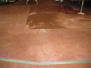 Old dairy floor subject to hot cleaning chemicals
